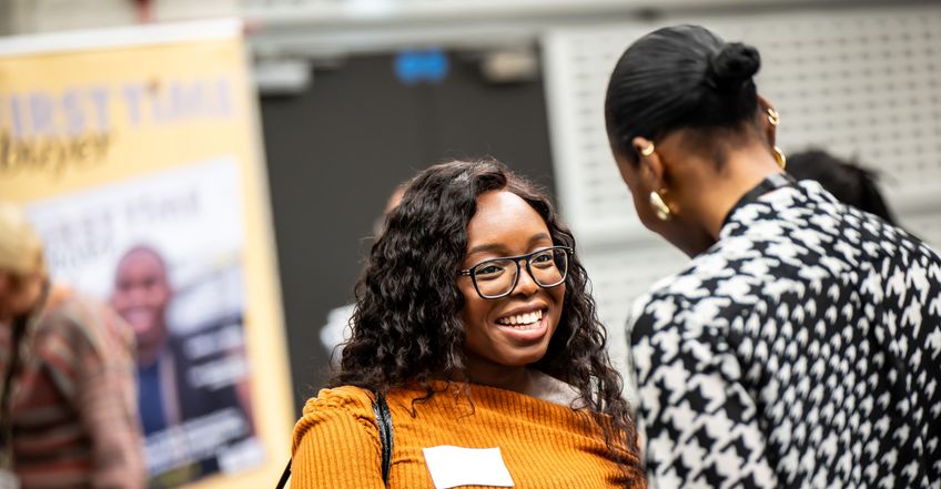 Woman smiling at the London Home Show by Share to Buy Live