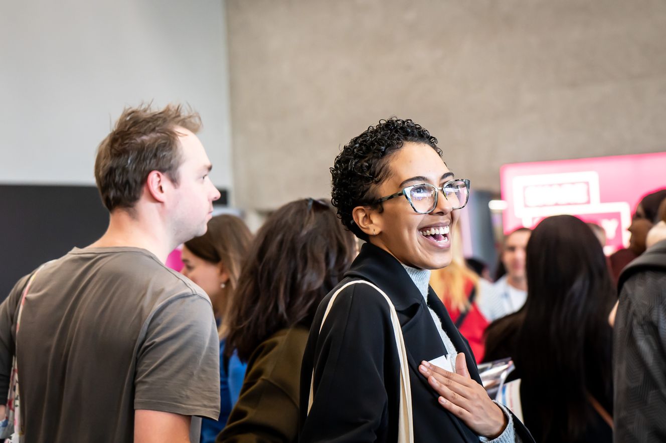 Woman smiling at the London Home Show by Share to Buy Live